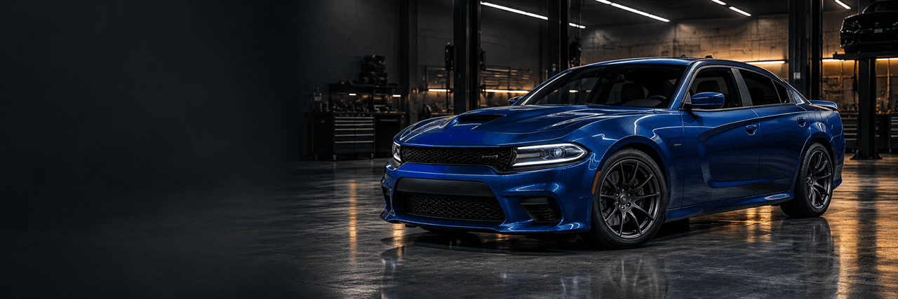 Blue performance sedan in a workshop